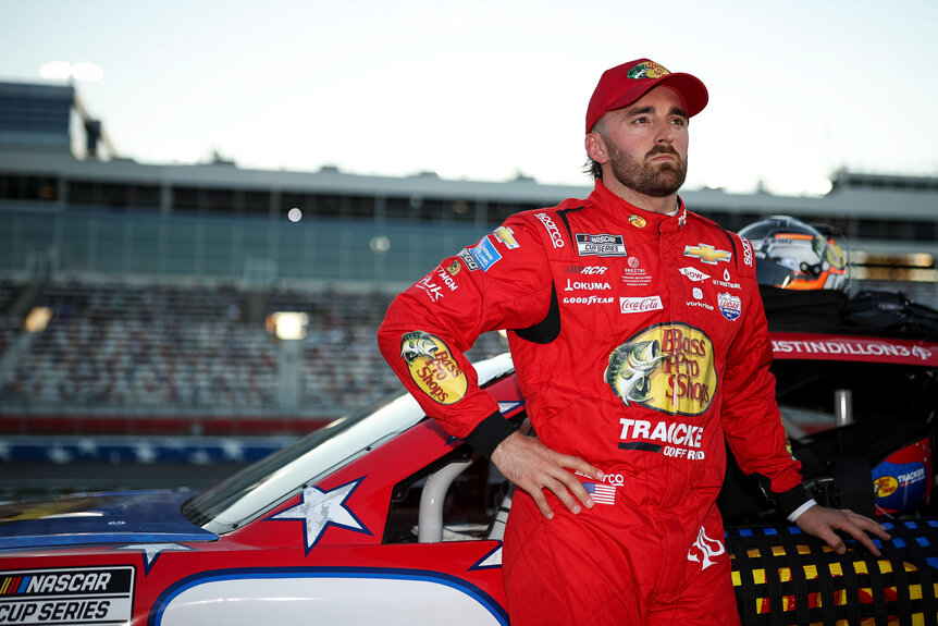 Austin Dillon posing against his racecar