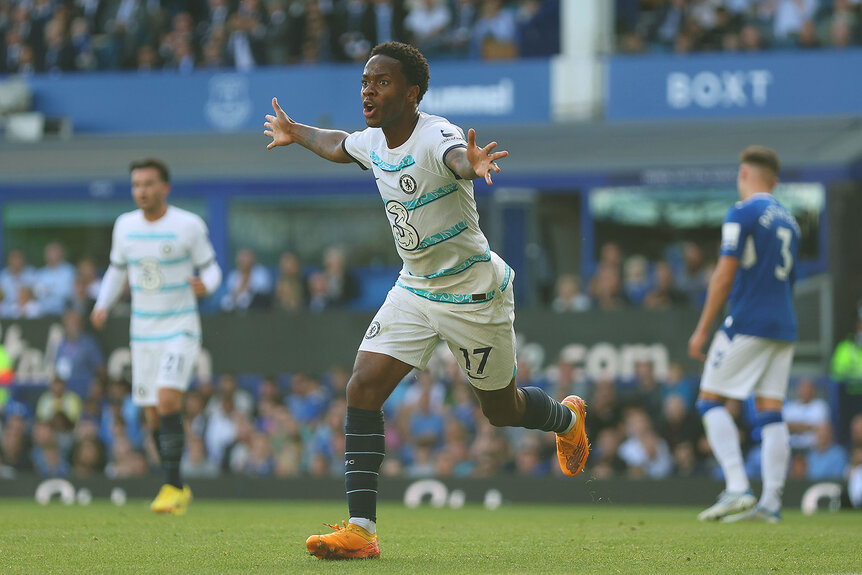 Premier League player running with his arms outstretched