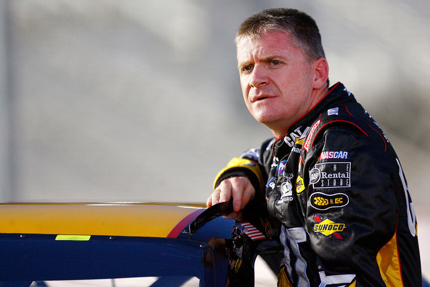 Jeff Burton leaning against his racecar