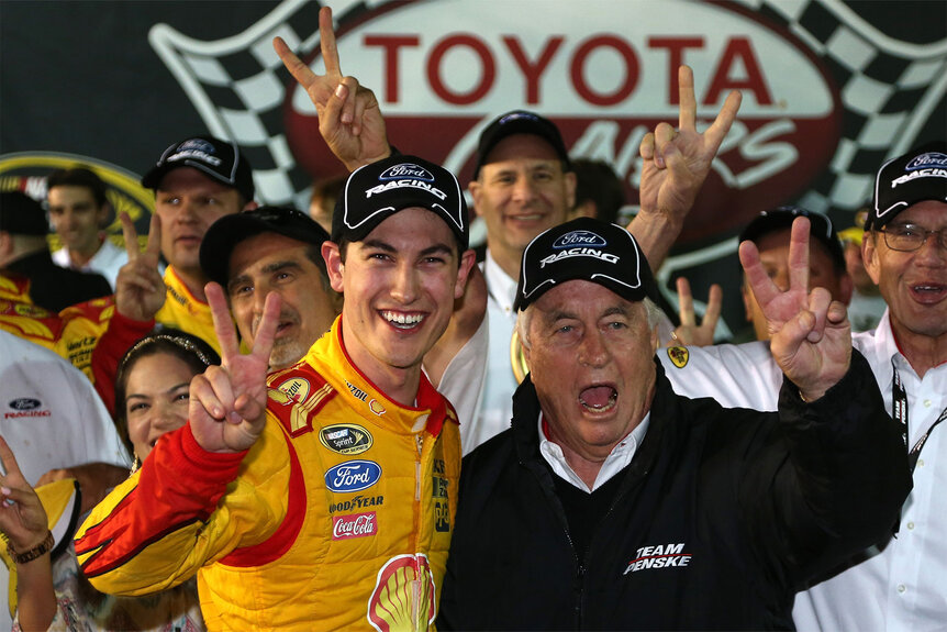 Roger Penske and Joey Logano celebrating a win together