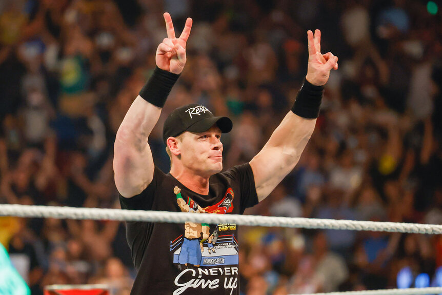 John Cena throwing up the peace sign while in the ring