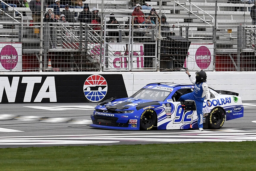 Josh Williams getting out of his car in the middle of the racetrack