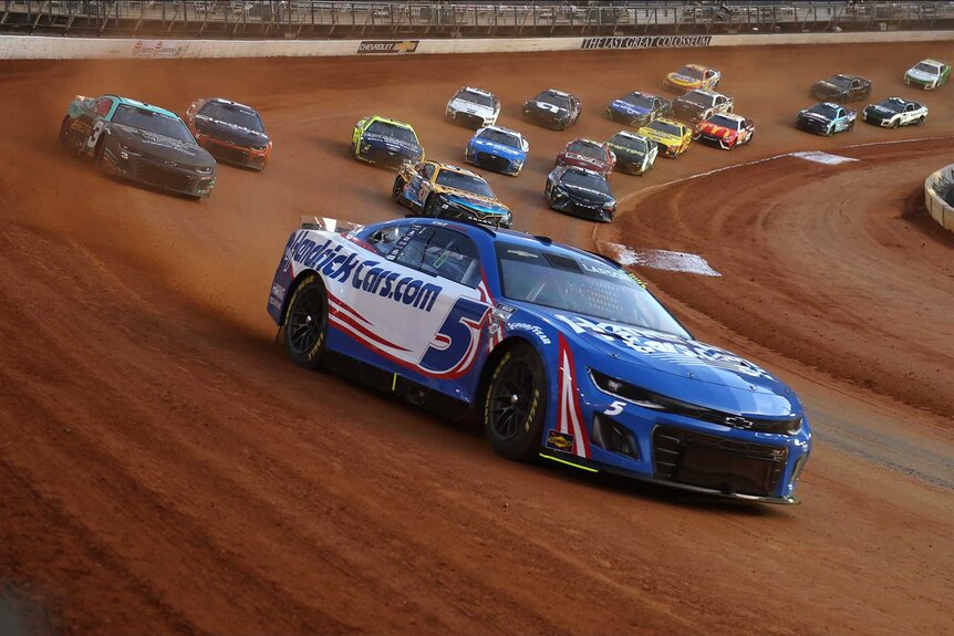 Kyle Larson, driver of the #5 HendrickCars.com Chevrolet, leads the field during the NASCAR Cup Series Food City Dirt Race at Bristol Motor Speedway