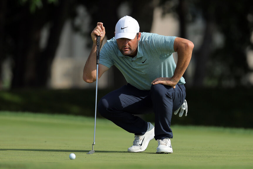 Scottie Scheffler of the United States lines up a putt on the 14th green during the first round of the Charles Schwab Challenge