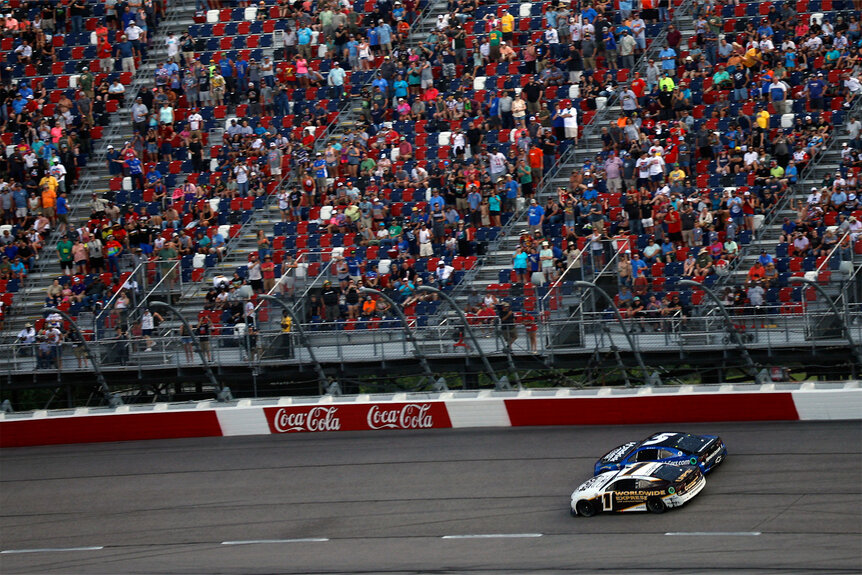 Ross Chastain, driver of the #1 Worldwide Express/UPS Chevrolet, and Kyle Larson, driver of the #5 HendrickCars.com Throwback Chevrolet, race during the NASCAR Cup Series Goodyear 400 at Darlington Raceway