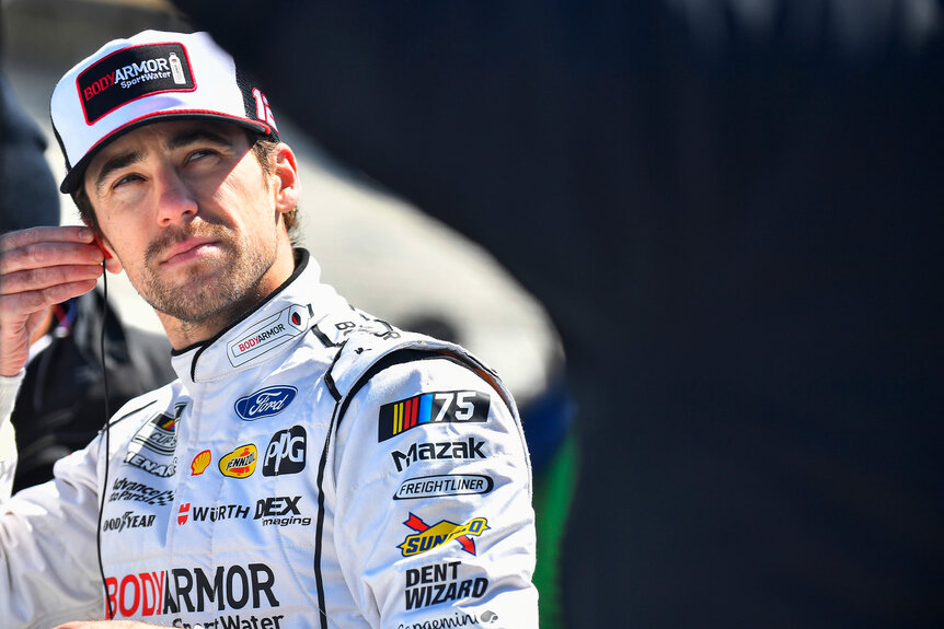 Ryan Blaney adjusts his ear piece during NASCAR Cup Series Qualifying for the Ambetter Health 400