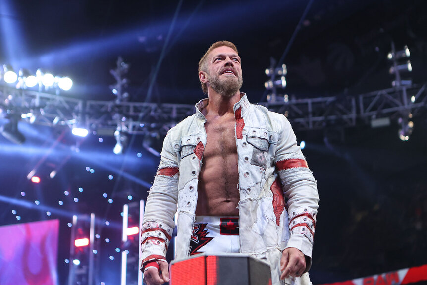 Edge stands on the ropes and looks out at the crowd