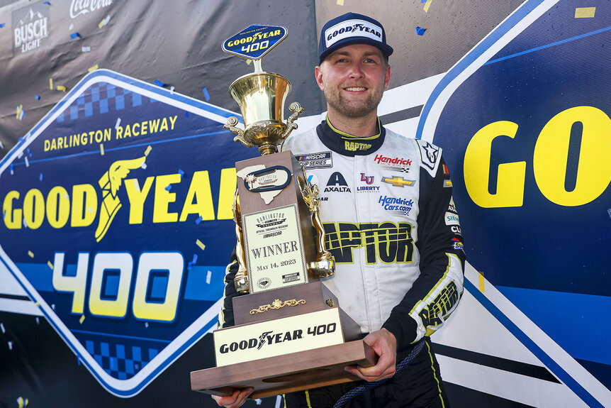 William Byron holds up his trophy after winning the Good Year 400 race