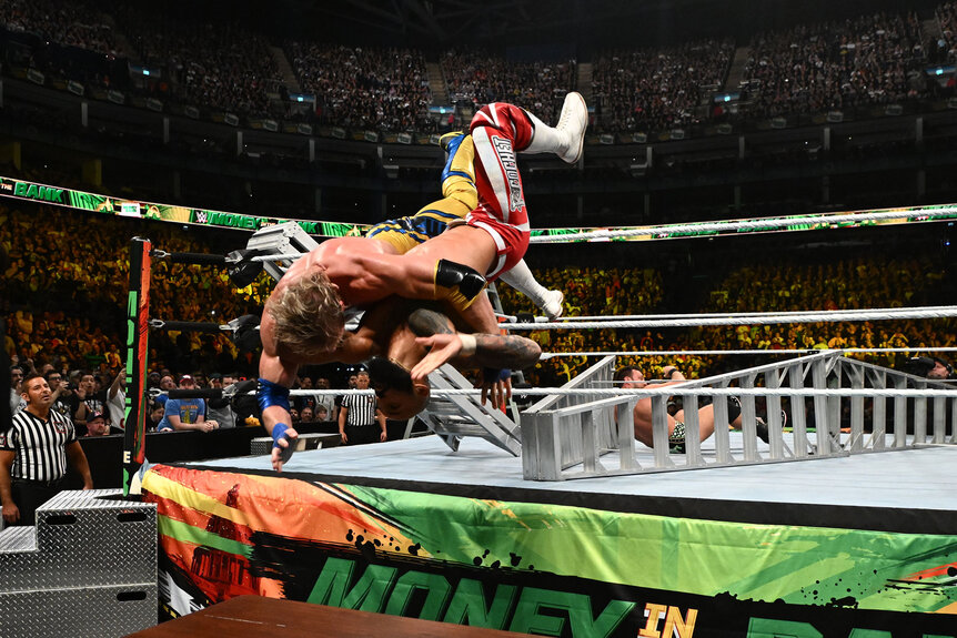 Logan Paul and Ricochet dive into a table during their Money In The Bank match