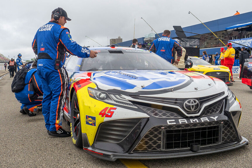 Crew members of Tyler Reddick prepare the car