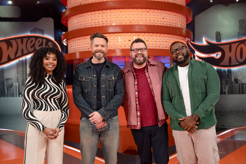 Dalal Elsheikh, Joel McHale, Rutledge Wood, and Hertrech Eugene Jr. on the Hot Wheels set