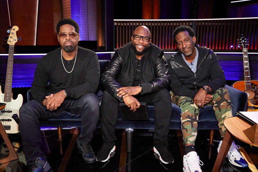 Nathan Morris, Wanya Morris, Shawn Stockman of Boyz II Men Sitting in a recording studio together.