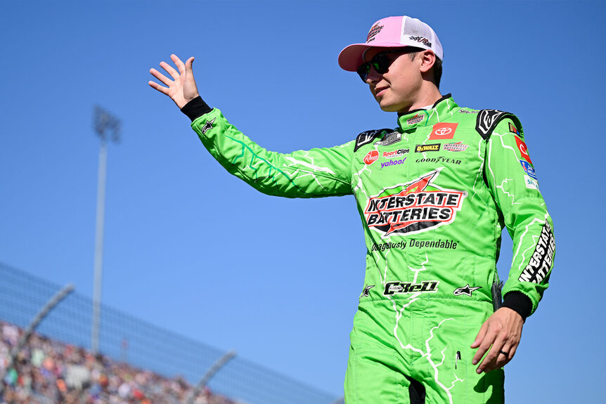 Christopher Bell waves to fans as he walks onstage during driver intros