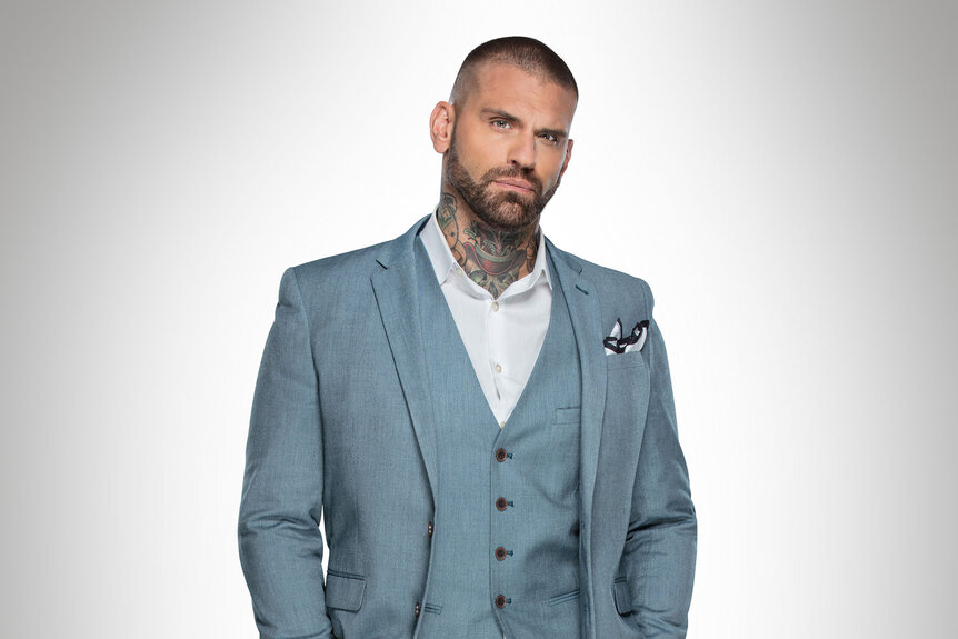 Corey Graves wearing an ash blue suit