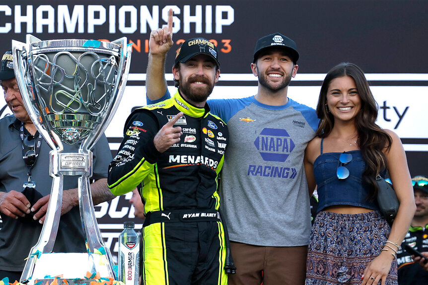 Ryan Blaney, Chase Elliott, and Gianna Tulio pose with Ryan's trophy