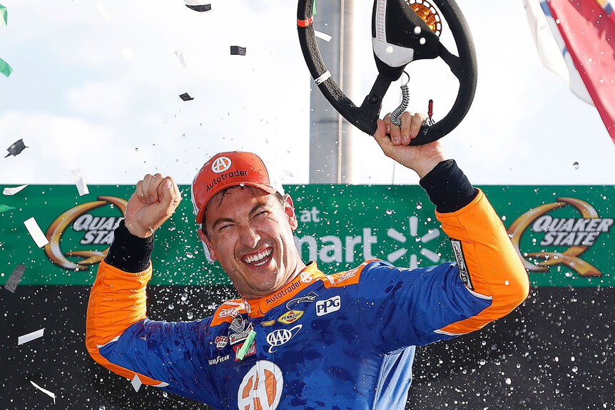 Joey Logano celebrates in victory lane after winning the NASCAR Cup Series Quaker State 400