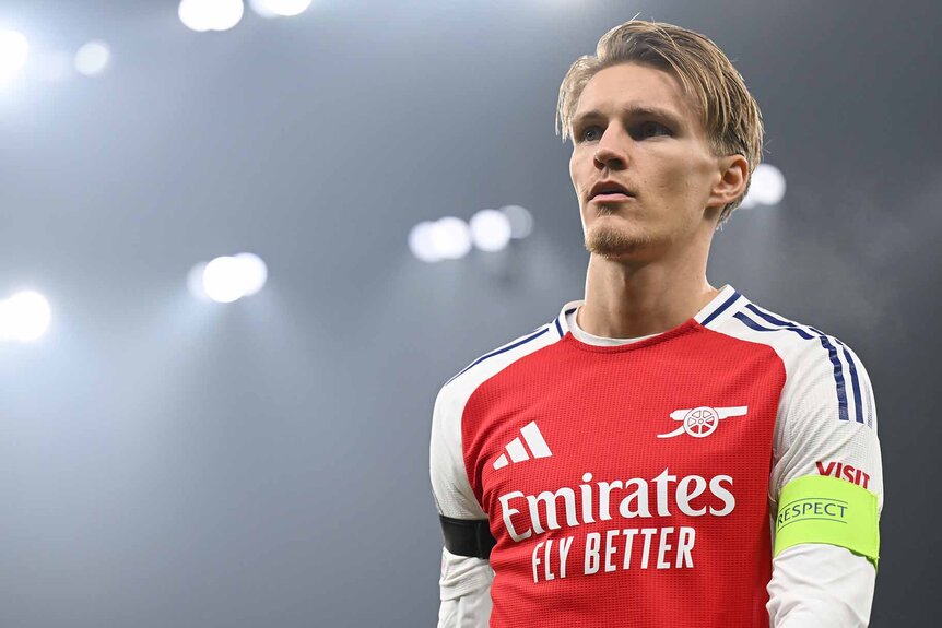 Martin Odegaard of Arsenal is illuminated by stadium lights.